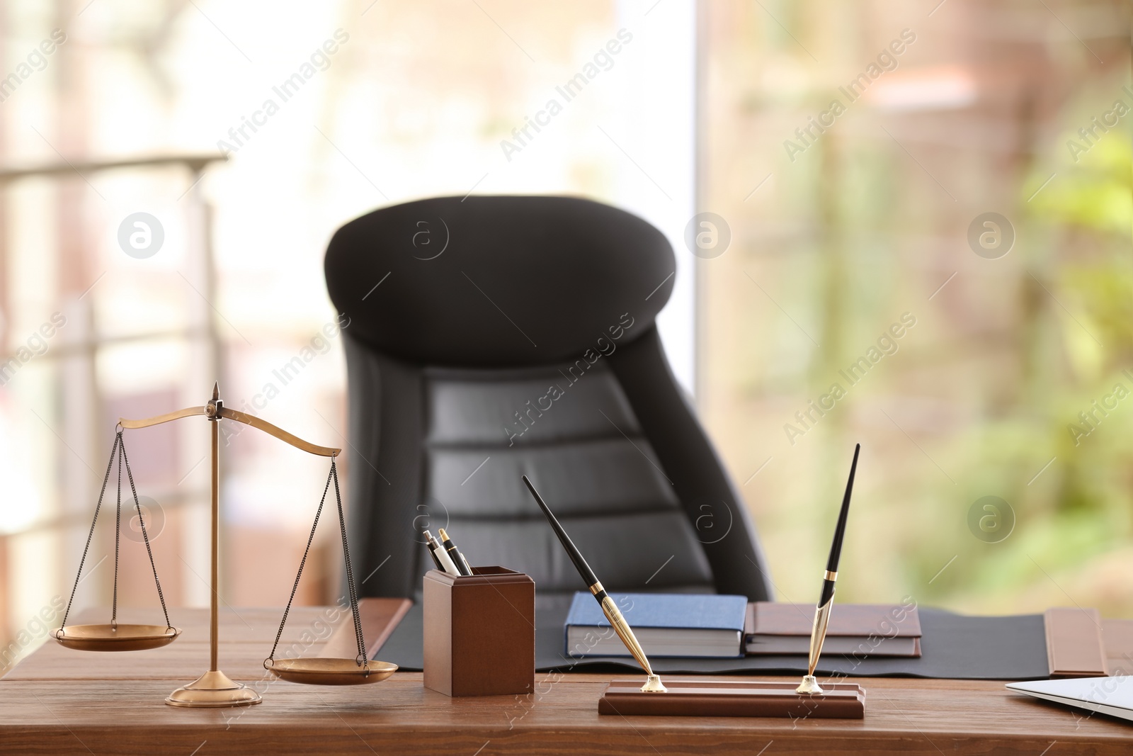 Photo of Table with scales of justice in lawyer's office