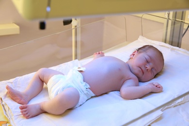 Photo of Newborn child under ultraviolet light in hospital