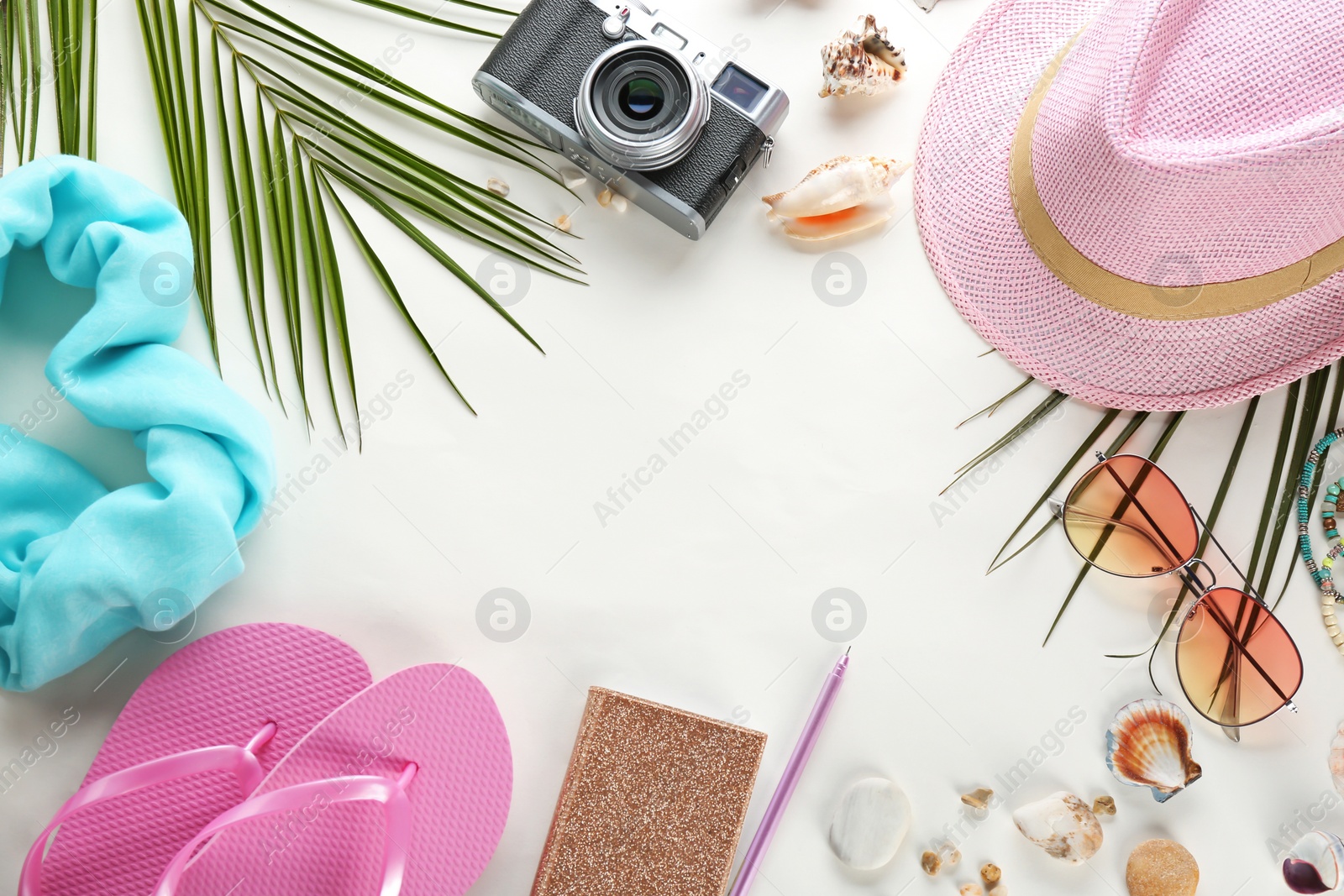 Photo of Flat lay composition with stylish hat, camera and beach objects on white background