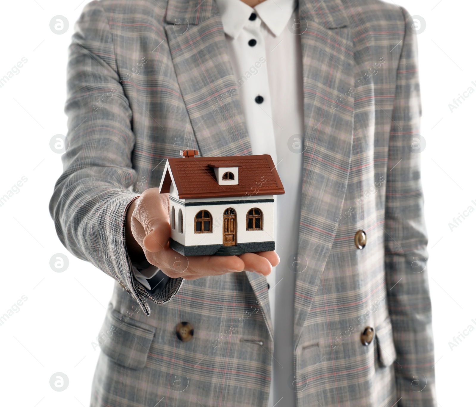 Photo of Real estate agent holding house model on white background, closeup