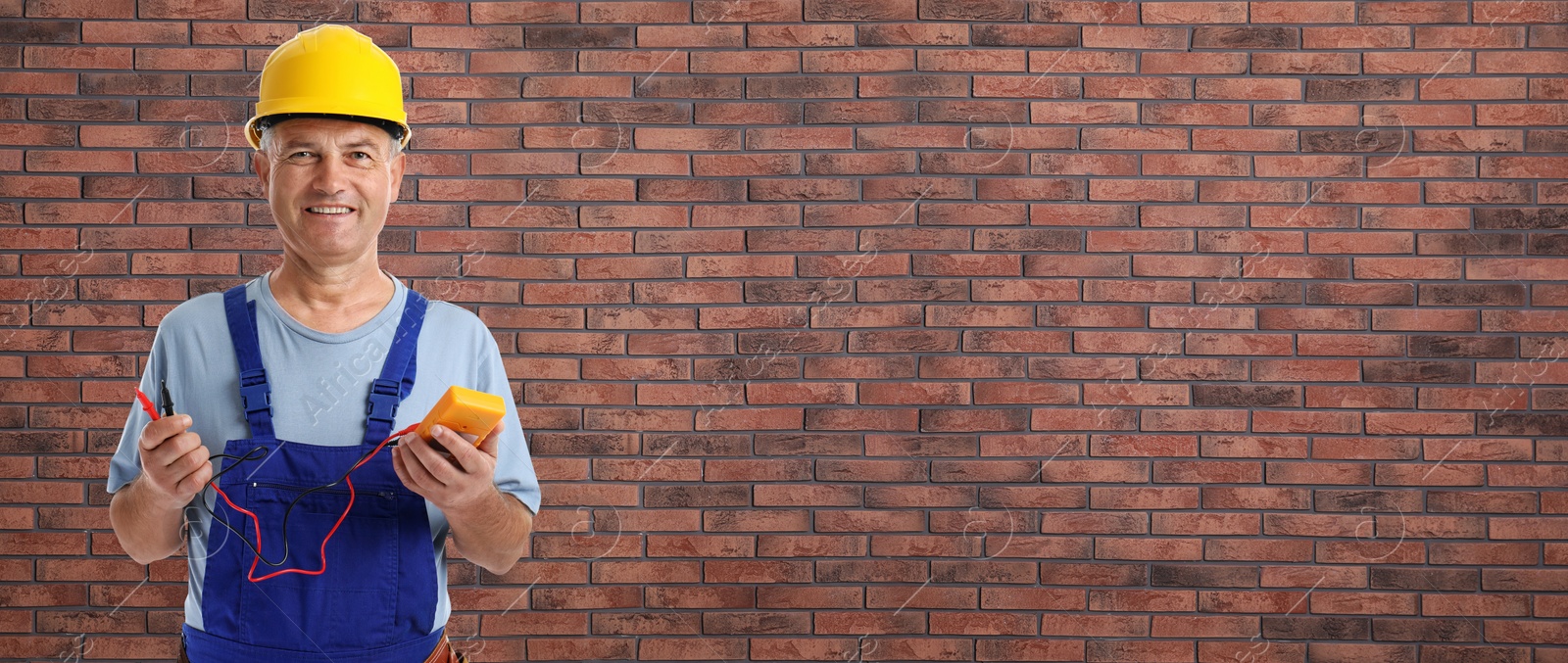 Image of Electrician with multimeter near brick wall, space for text. Banner design