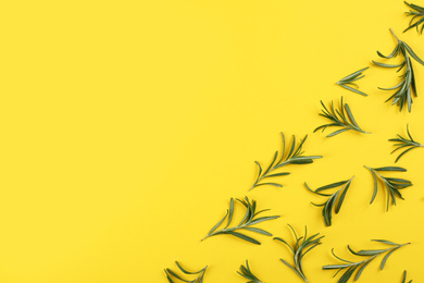 Photo of Flat lay composition with fresh rosemary on yellow background. Space for text