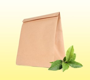 Image of Paper bag and green leaves on light background. Eco friendly lifestyle