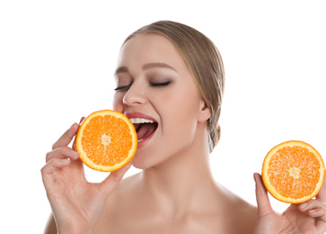 Photo of Young woman with cut orange on white background. Vitamin rich food