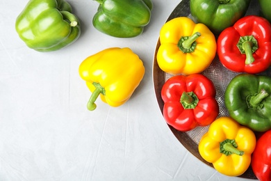 Dish with ripe paprika peppers on light background, top view