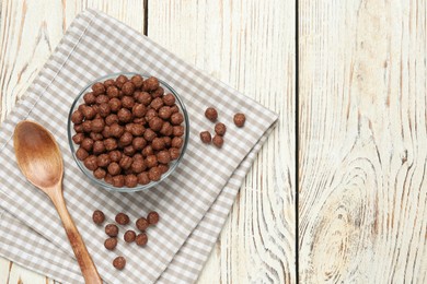 Tasty corn balls and spoon on white wooden table, top view with space for text. Healthy breakfast cereal