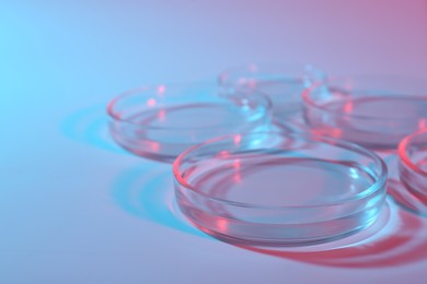 Many clean petri dishes on color background, closeup. Space for text