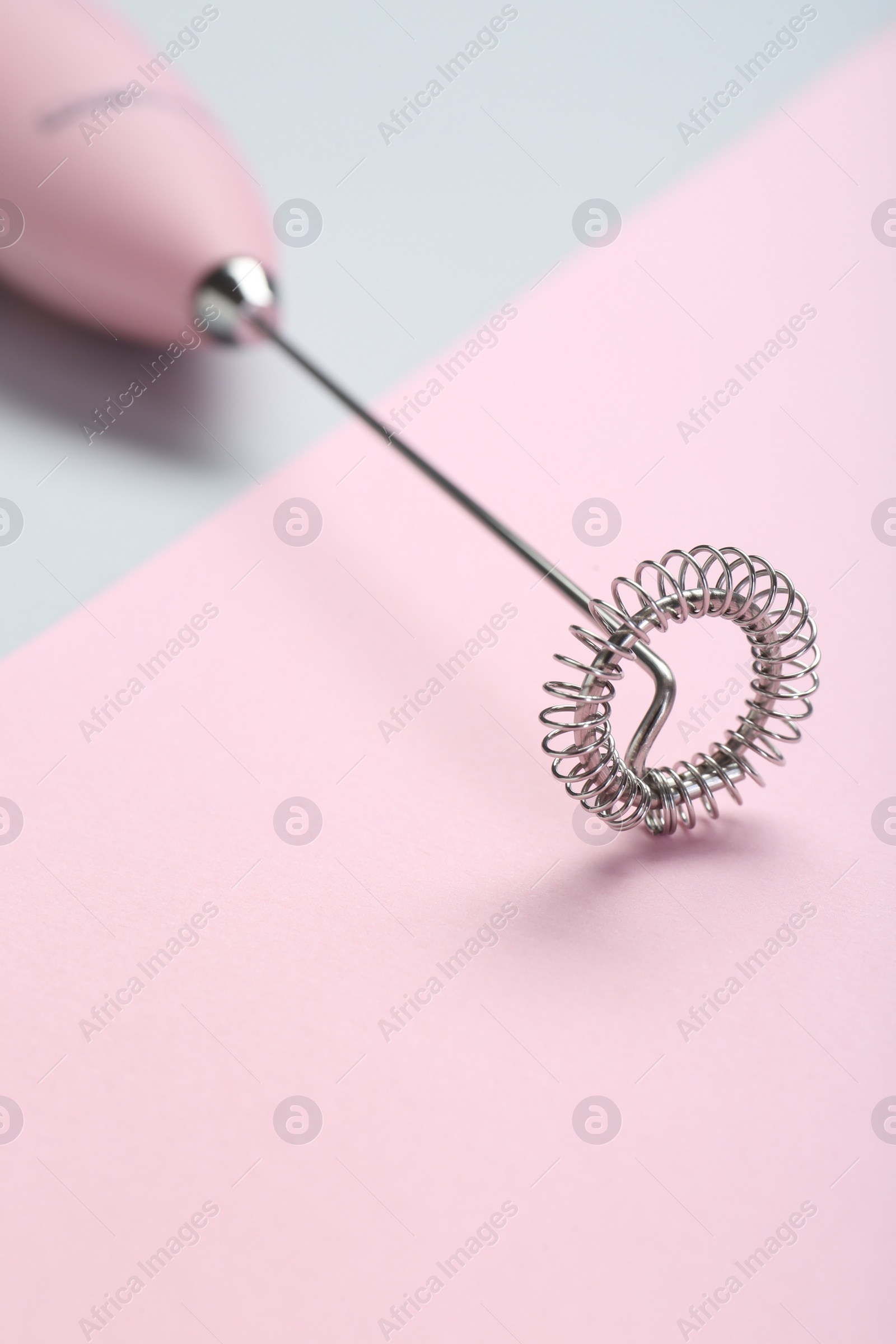 Photo of Pink milk frother wand on color background, closeup