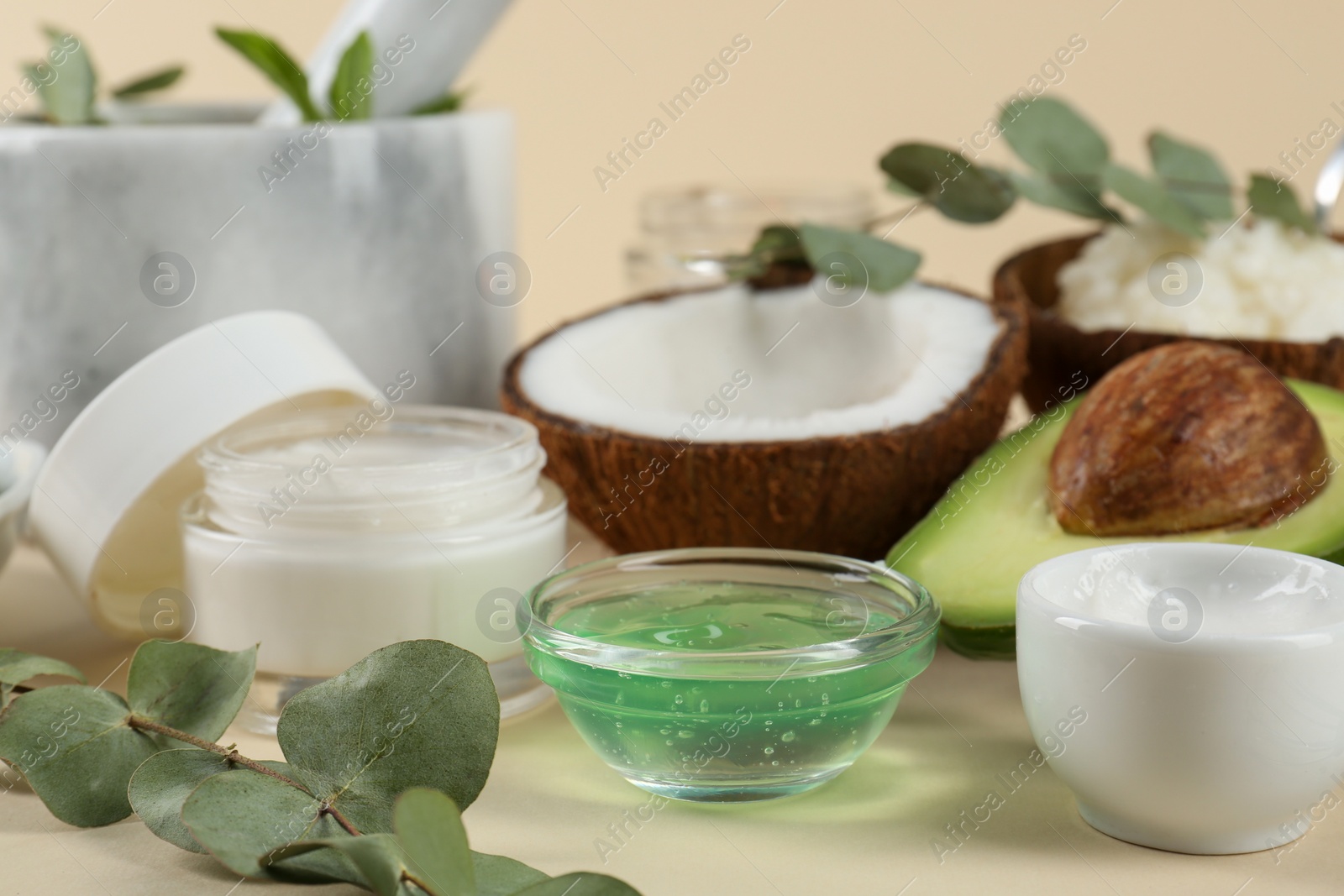 Photo of Homemade cosmetic products and fresh ingredients on beige background, closeup. DIY beauty recipe