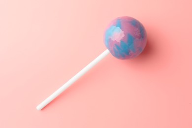 Tasty lollipop on pink background, top view