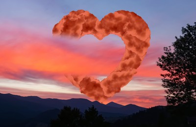 Image of Mountain landscape at sunset. Beautiful sky with heart formed from clouds