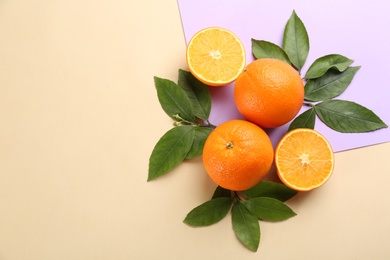 Delicious oranges on color background, flat lay. Space for text