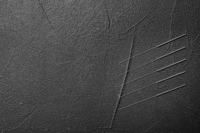 Needles for acupuncture on dark background, top view