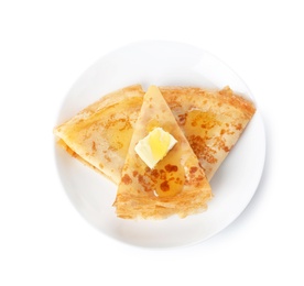 Photo of Tasty thin folded pancakes with butter and honey on plate against white background, top view