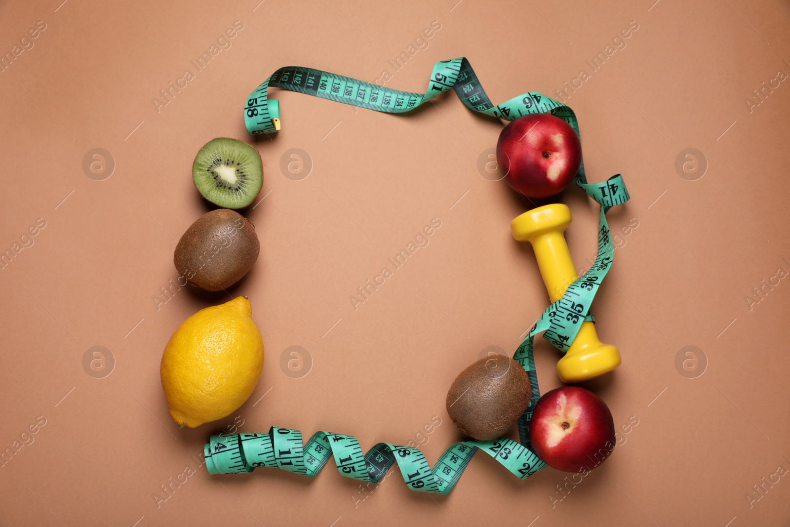 Photo of Frame of measuring tape, dumbbell and fresh fruits on light brown background, flat lay with space for text. Low glycemic index diet