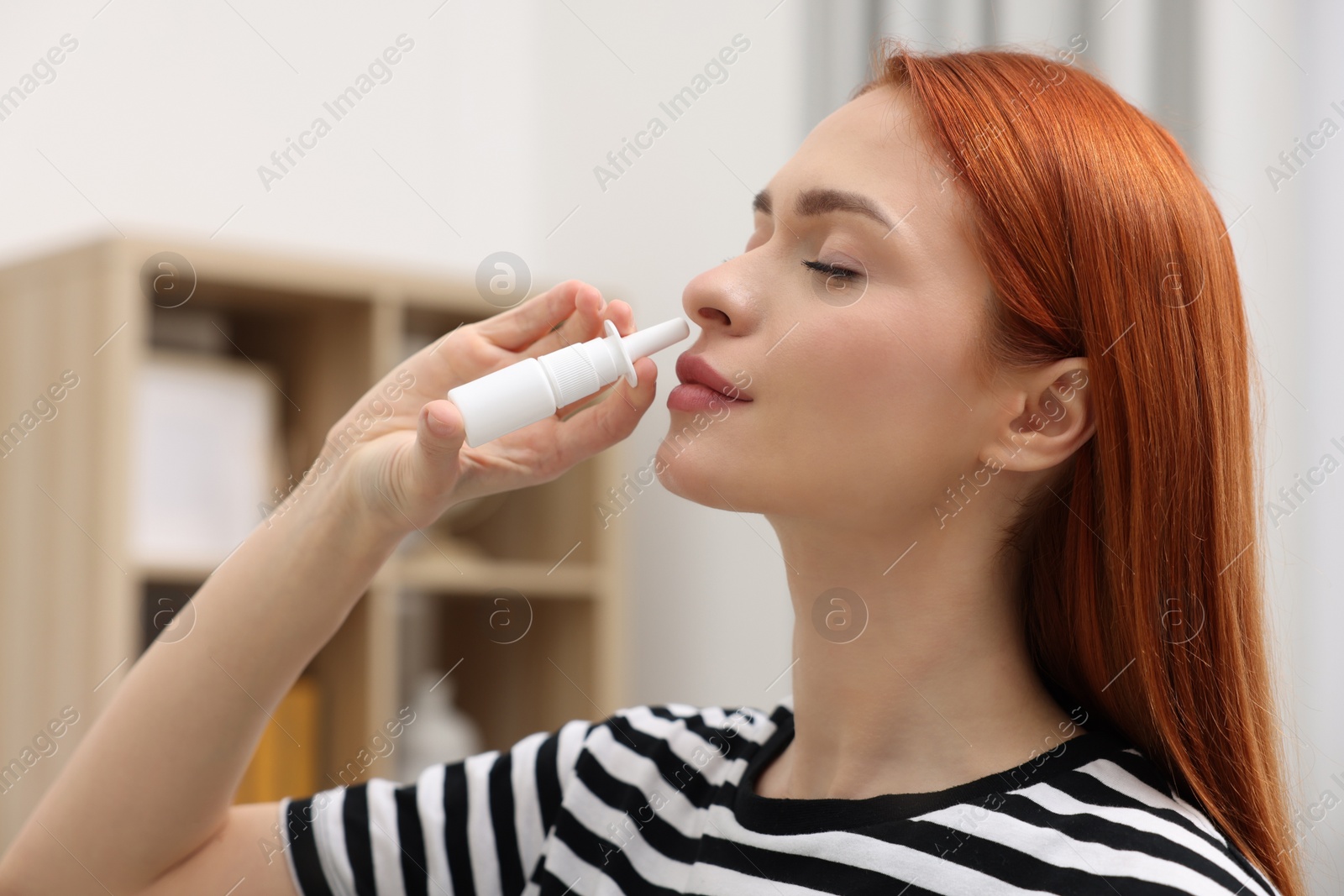 Photo of Medical drops. Woman using nasal spray at home