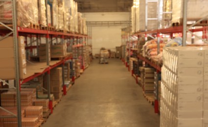 Warehouse with lots of products, blurred view. Wholesale business