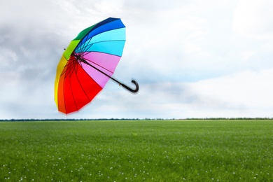 Image of Open umbrella blown by wind gust outdoors