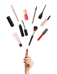 Image of Woman holding red lipstick as magic wand making other decorative cosmetics flying on white background, closeup