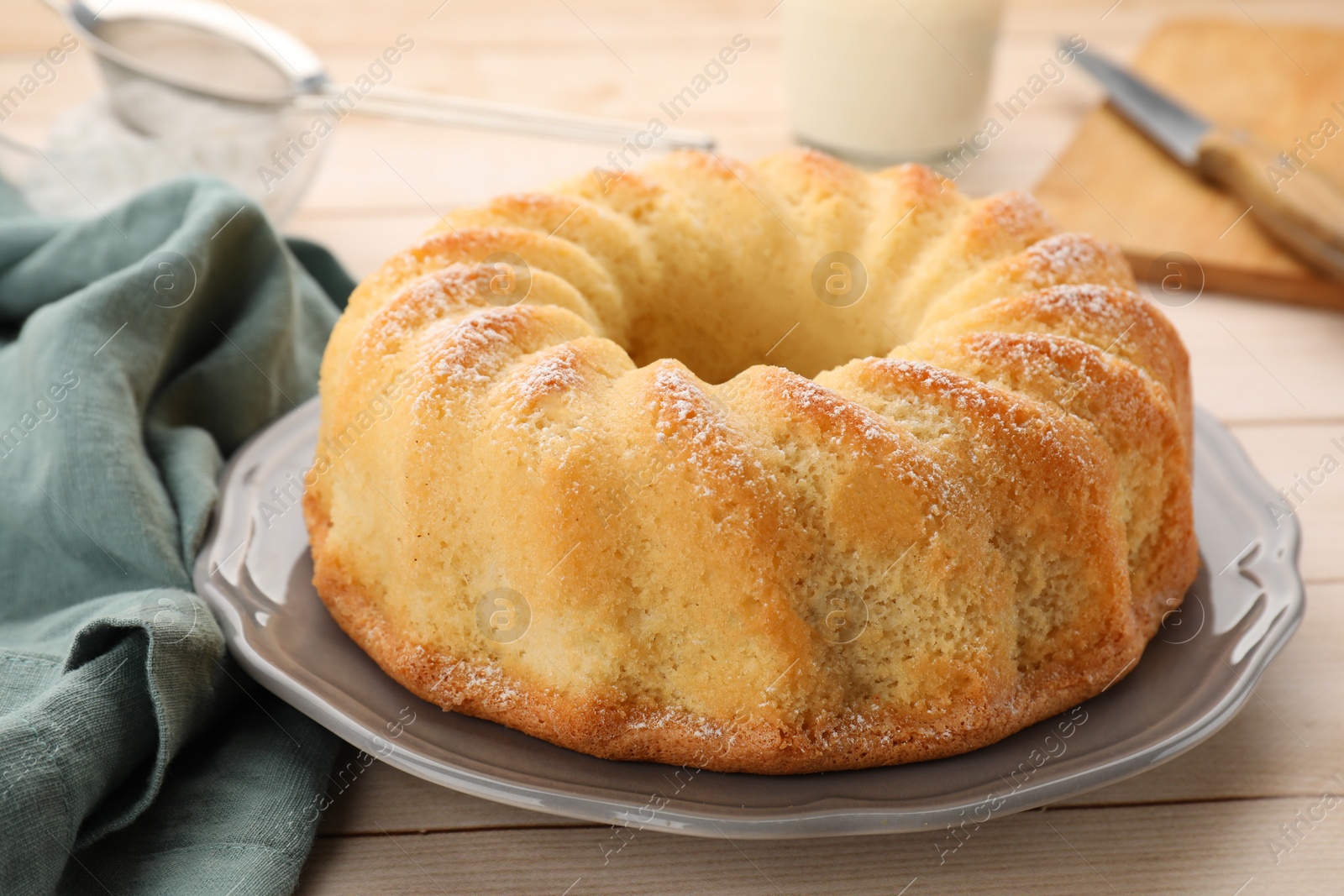 Photo of Delicious freshly baked sponge cake on wooden table, closeup