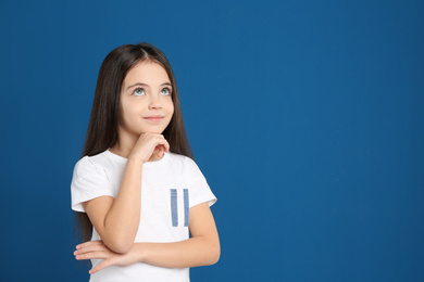 Photo of Portrait of cute little girl on blue background
