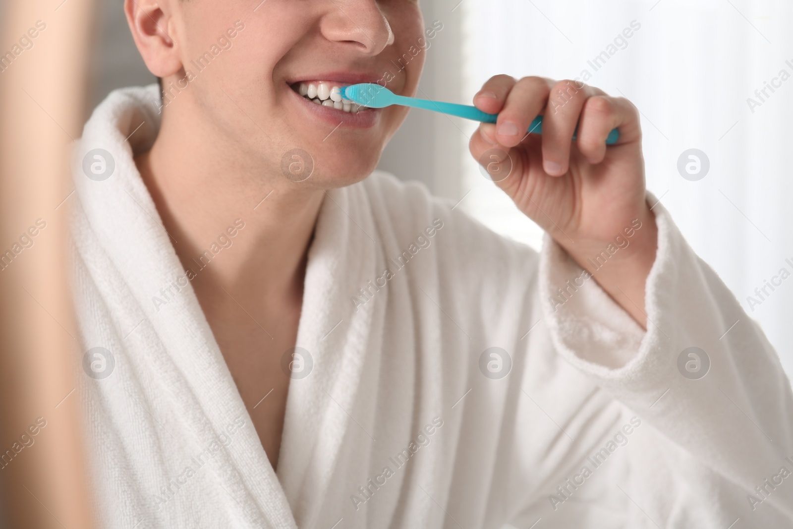 Photo of Man brushing his teeth with toothbrush, closeup