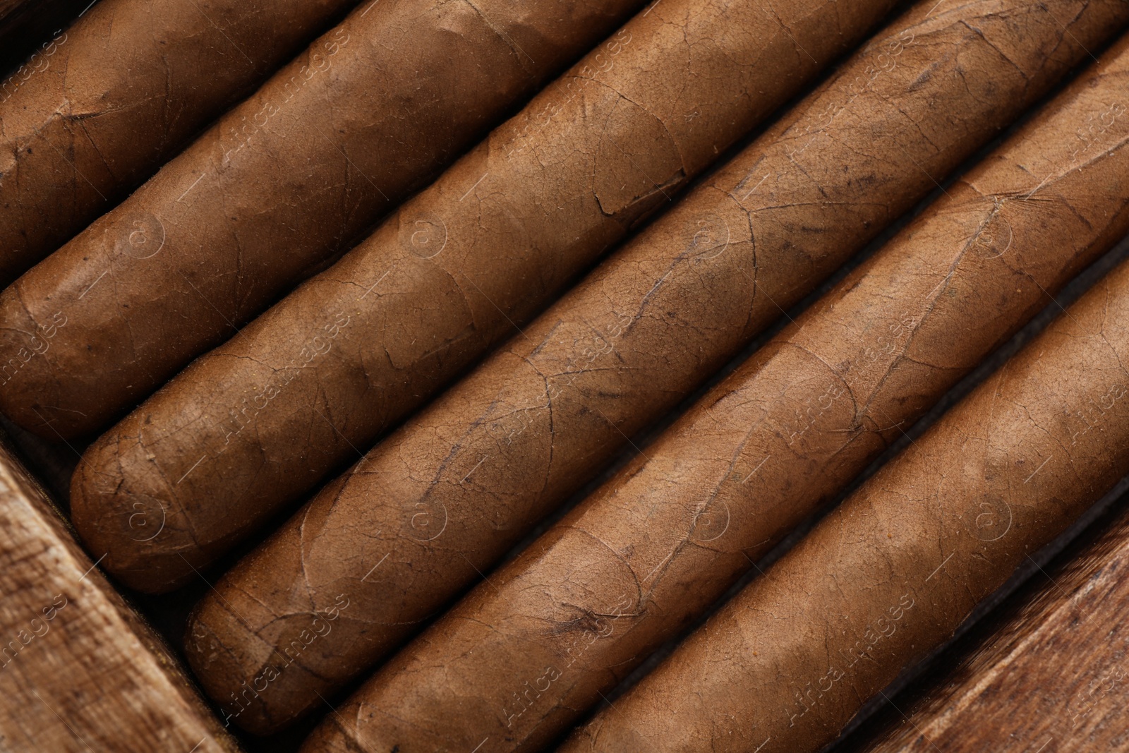 Photo of Closeup of many cigars as background, top view