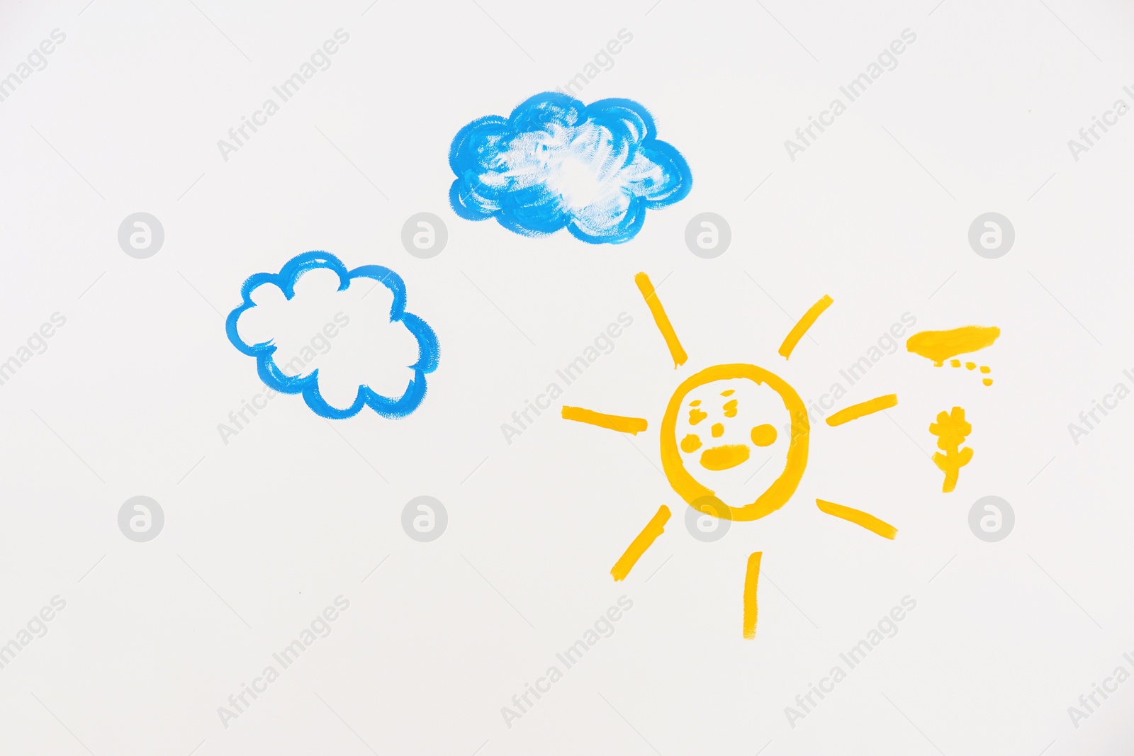 Photo of Children's paintings of sun and clouds on white background