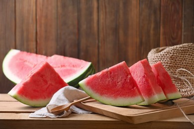 Sliced fresh juicy watermelon on wooden table, space for text