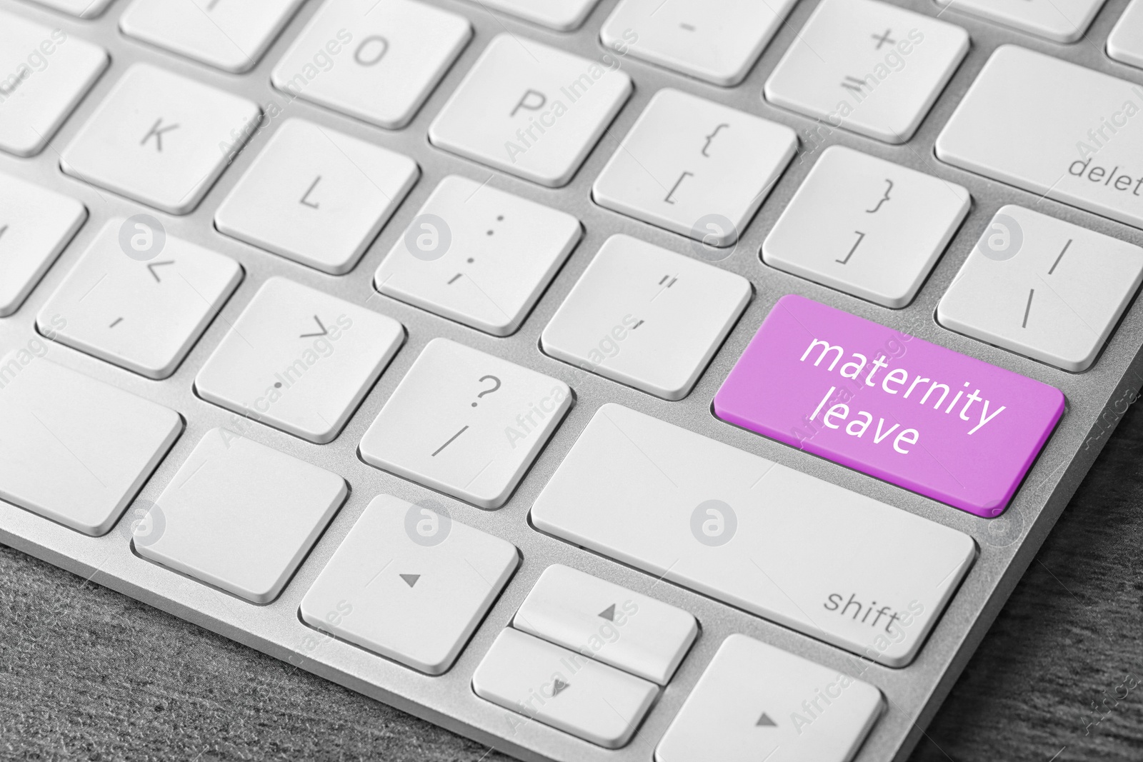 Image of Modern computer keyboard with text MATERNITY LEAVE on table, closeup