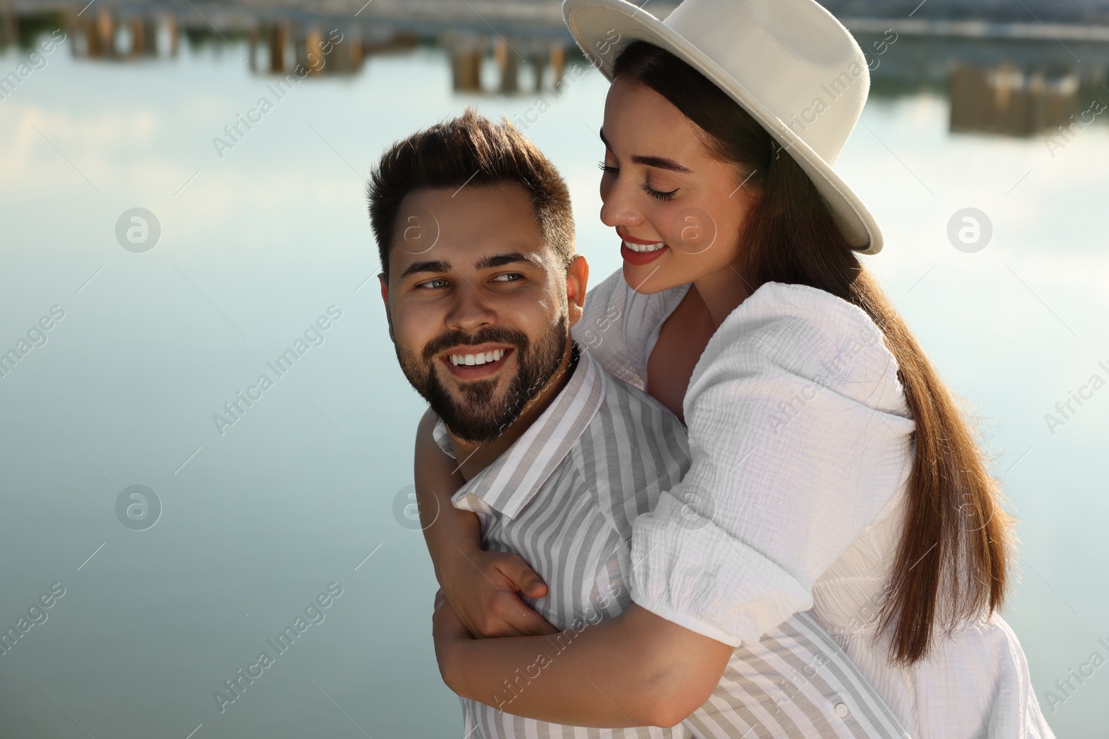 Photo of Romantic date. Beautiful couple spending time together near lake