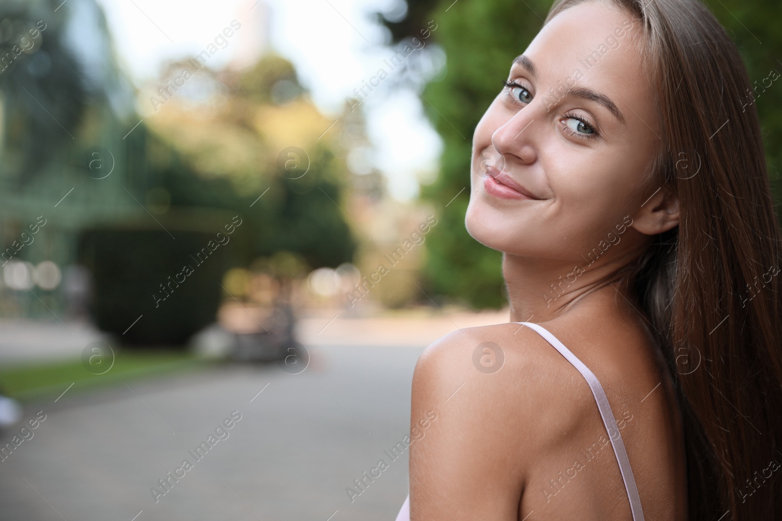 Photo of Portrait of beautiful young woman on city street, space for text