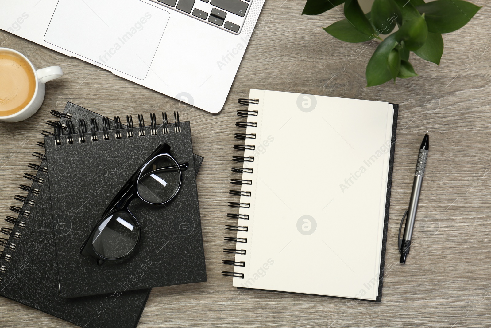 Photo of Flat lay composition with notebooks and laptop on wooden table