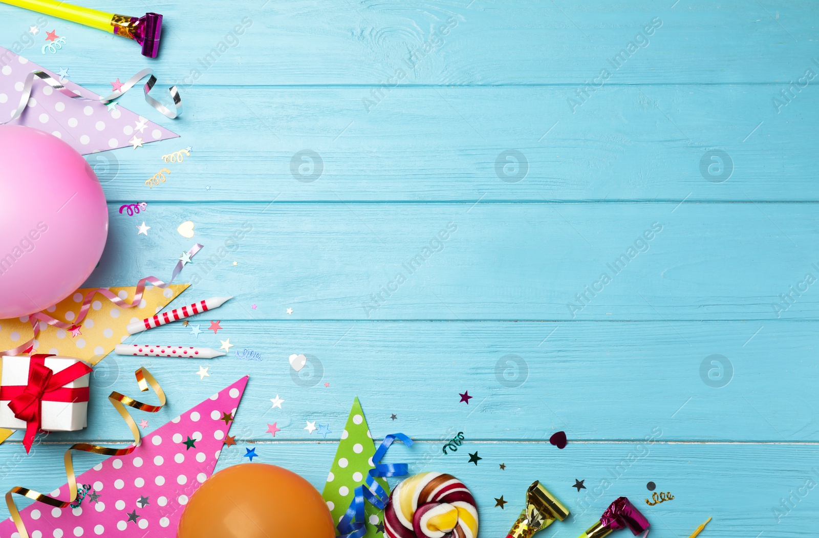 Photo of Flat lay composition with birthday party items on wooden background