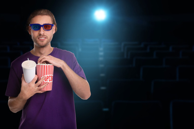 Image of Man with 3D glasses, beverage and popcorn in cinema, space for text