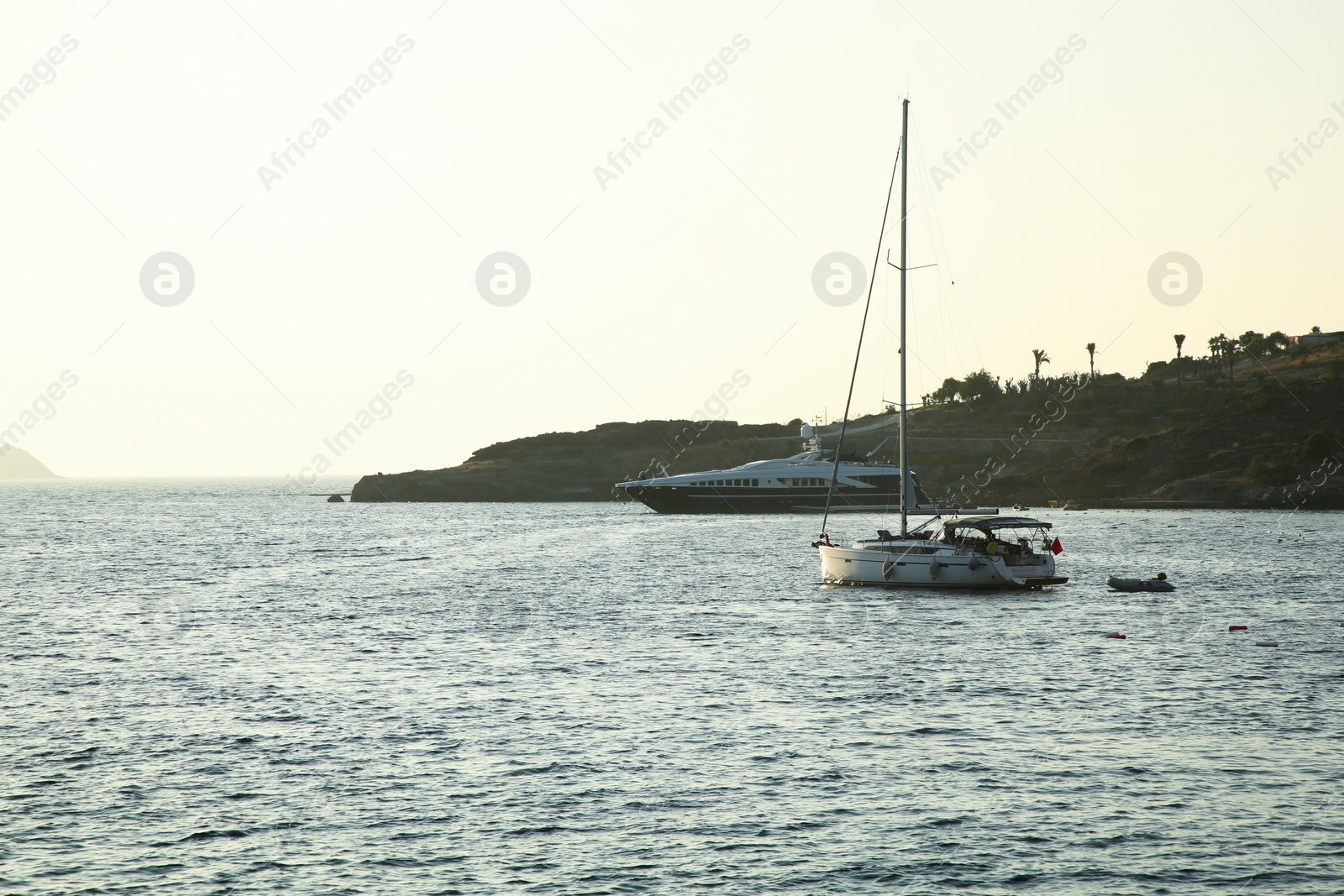 Photo of Beautiful view of calm sea with yacht and boats on summer day