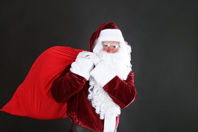 Photo of Portrait of Santa Claus with sack on black background