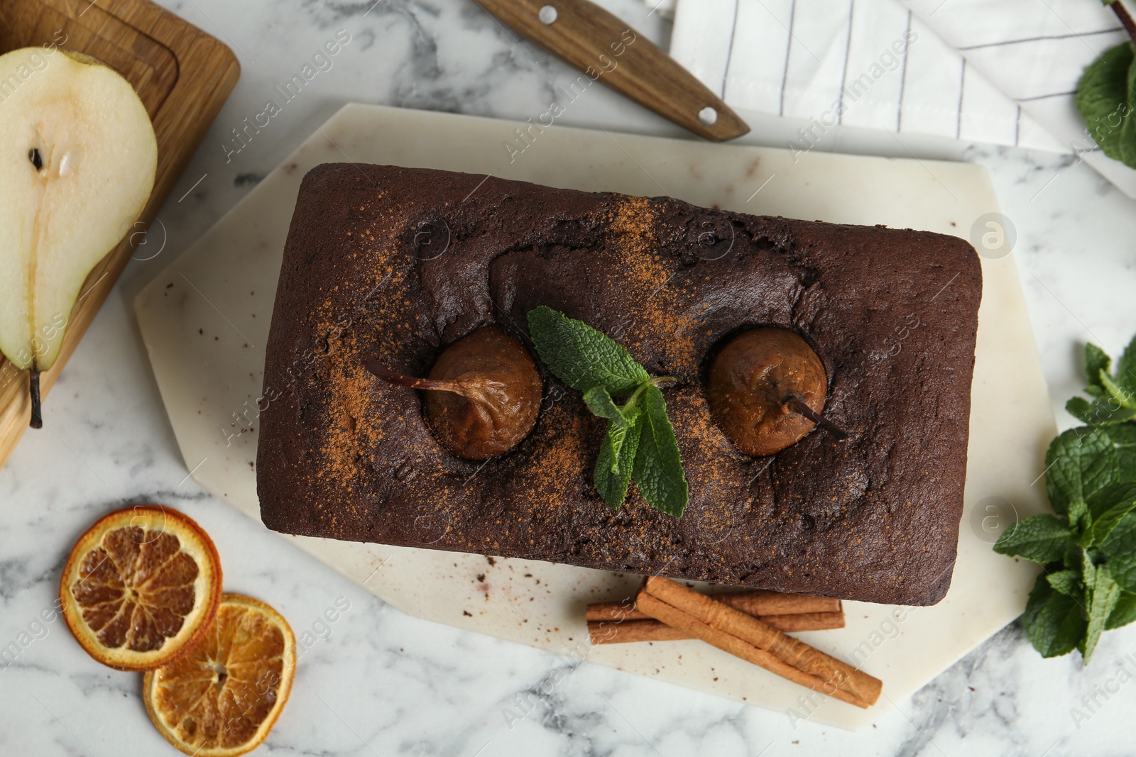 Photo of Flat lay composition with tasty pear bread on white marble table. Homemade cake