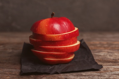 Photo of Fresh yummy sliced apple on wooden table