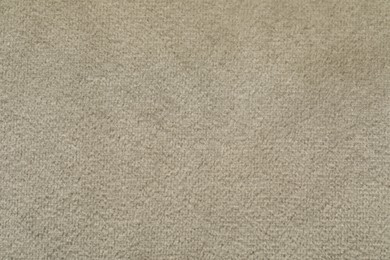 Photo of Texture of soft beige fabric as background, top view