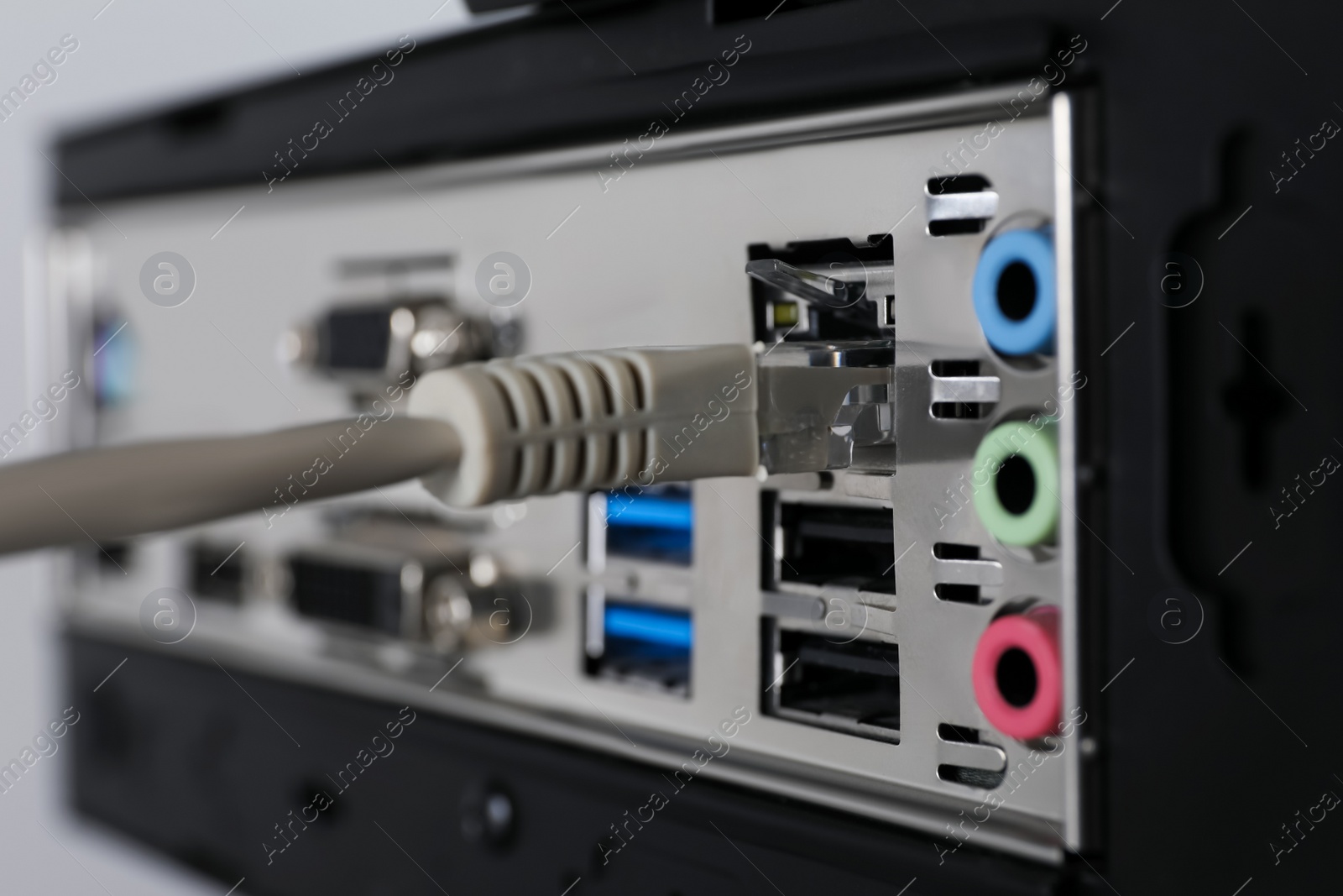 Photo of Connected cable to computer system unit, closeup. Internet communication