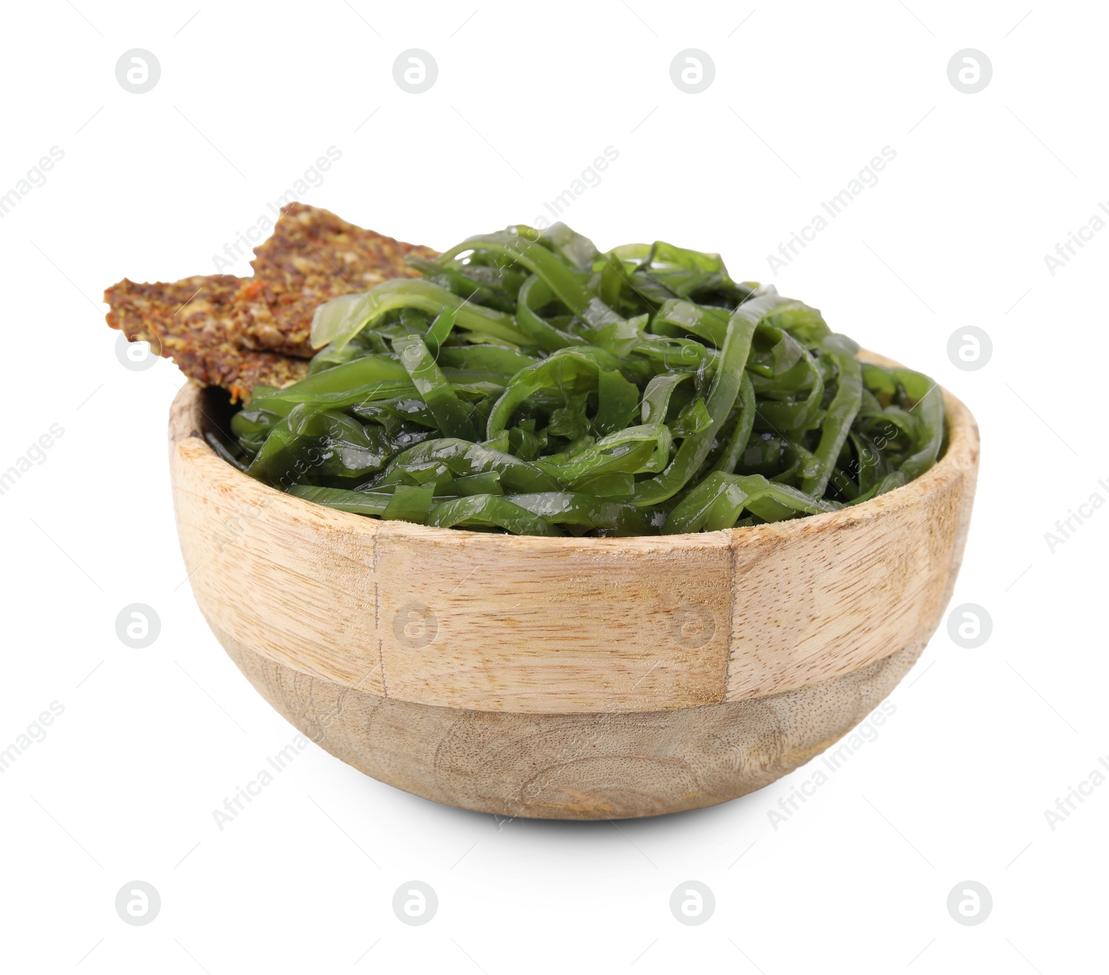 Photo of Tasty seaweed salad and crispbreads in bowl isolated on white