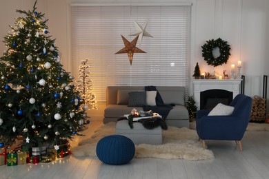 Cozy living room interior with beautiful Christmas tree and comfortable furniture