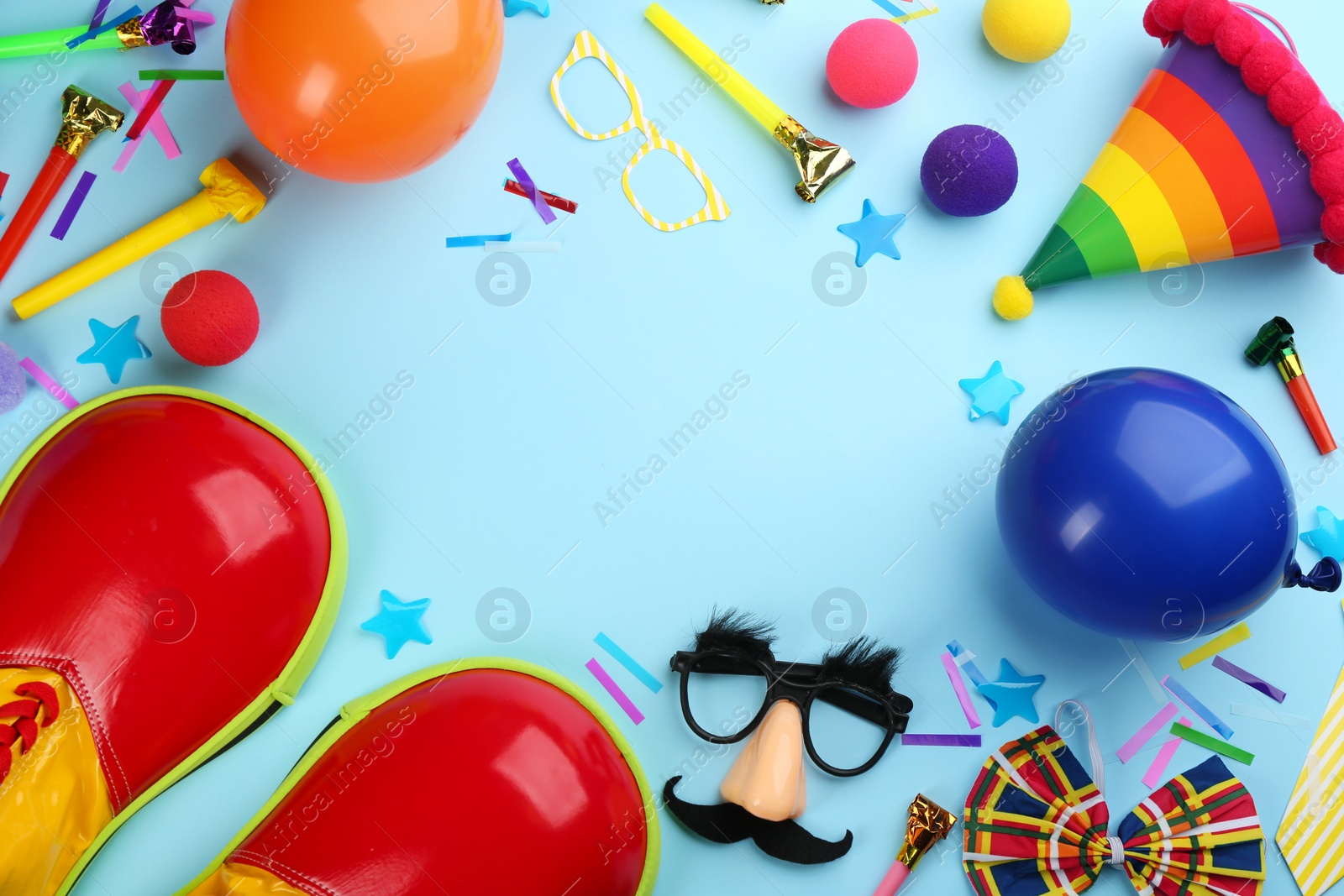 Photo of Clown accessories on light blue background, flat lay. Space for text