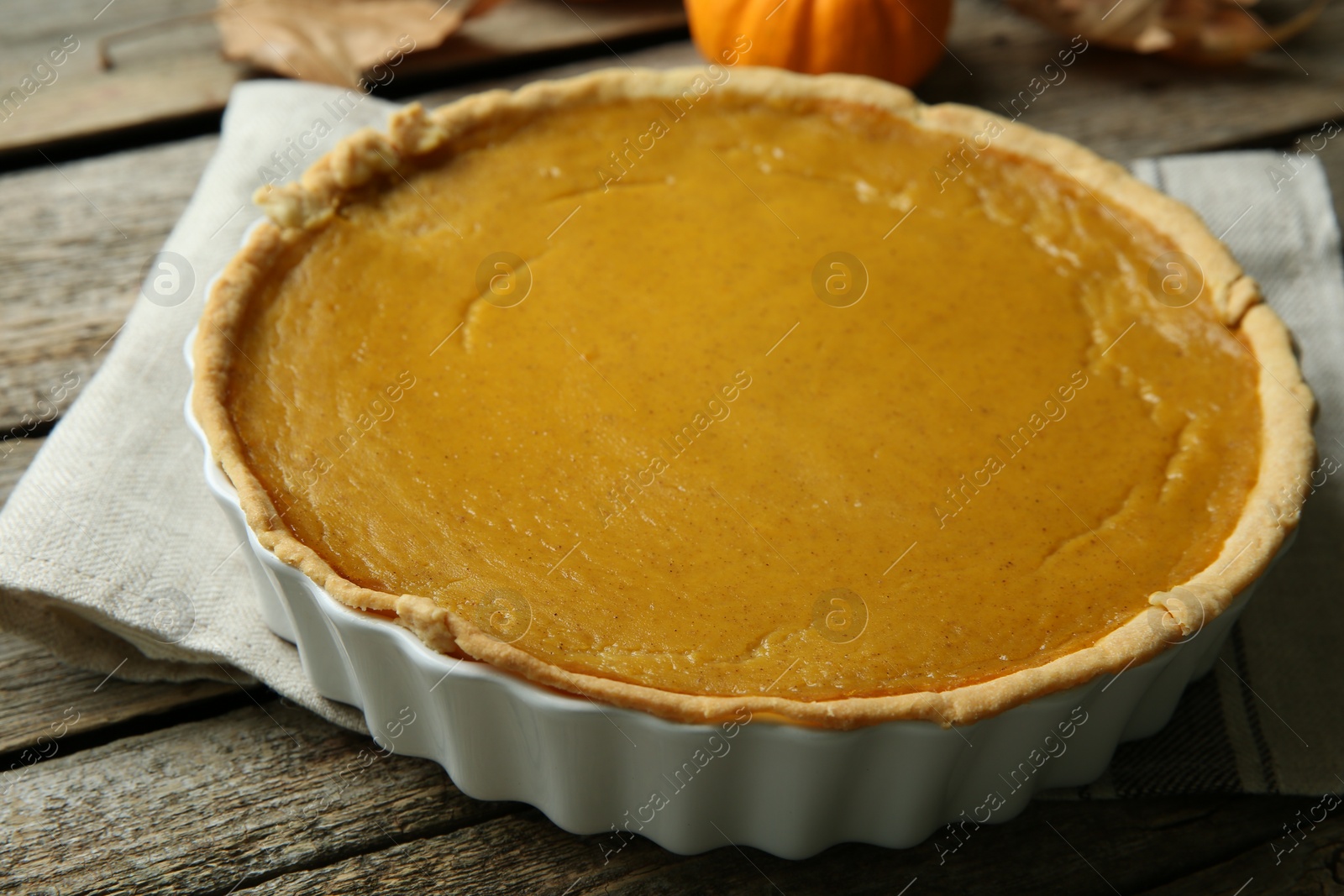 Photo of Delicious fresh pumpkin pie on wooden table, closeup