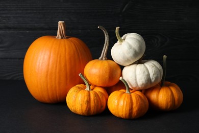 Photo of Thanksgiving day. Beautiful composition with pumpkins on black table