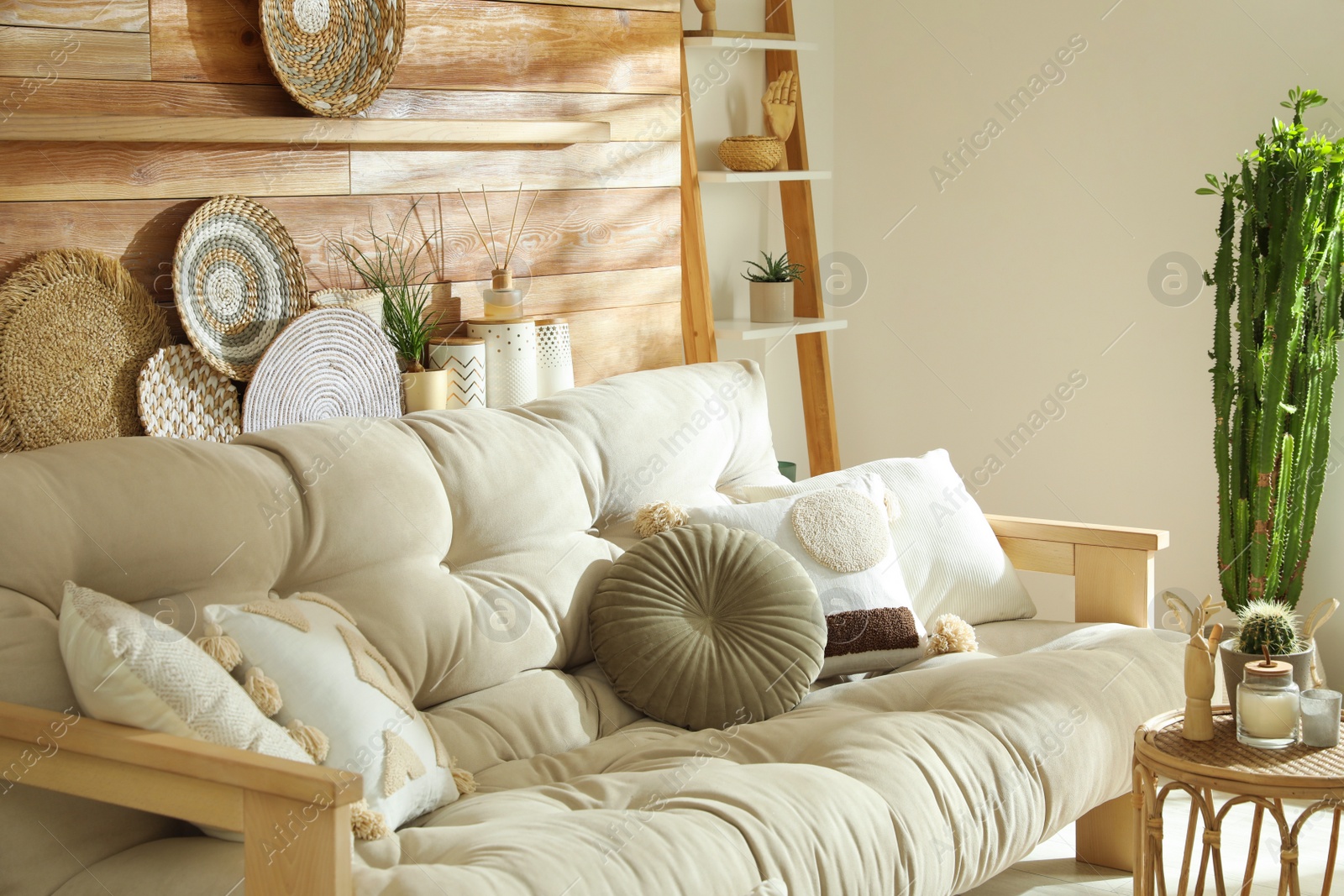 Photo of Stylish decor and comfortable sofa near wooden wall in living room. Interior design