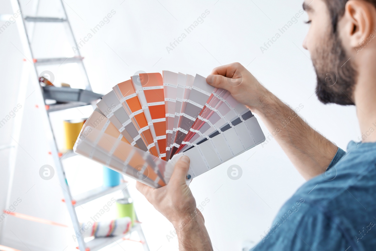 Photo of Young man with color palette on white background