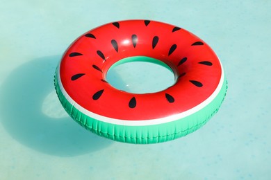 Photo of Inflatable ring floating on water in above ground swimming pool, closeup