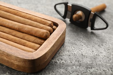 Photo of Box with cigars on grey table, closeup. Space for text